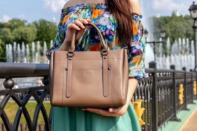 A woman with a brown leather bag

